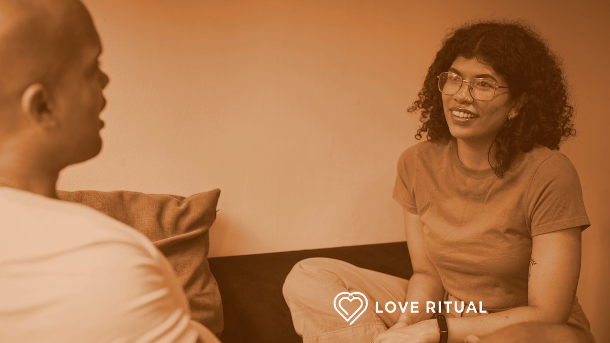 One partner talking while the other listens, sitting together on a sofa